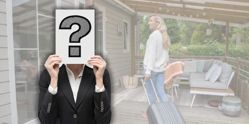 Concierge hiding behind a question mark sign while a guest arrives with her suitcase at a vacation rental