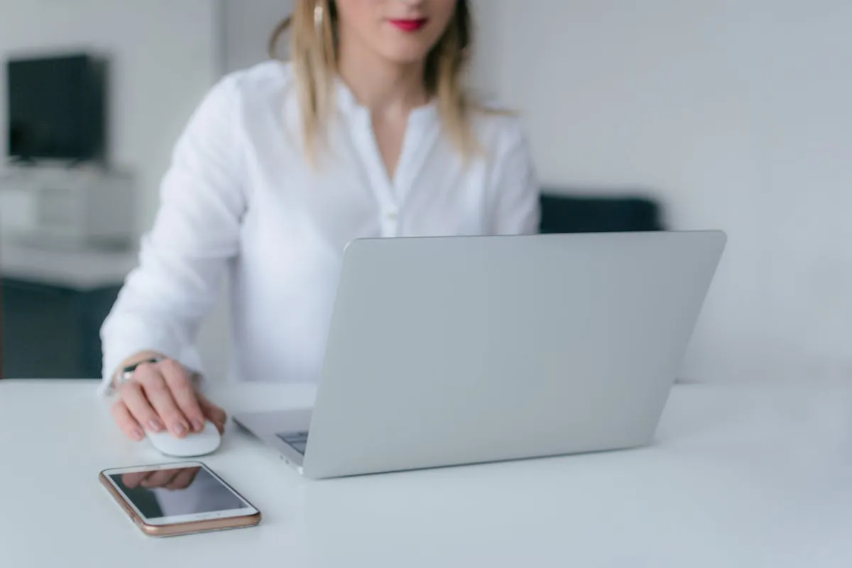 Host reviewing guest feedback on laptop at modern desk
