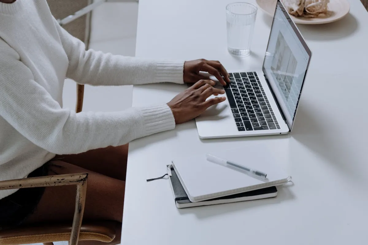 Property manager reviewing rental data on laptop with AI assistant helping analyze bookings and pricing