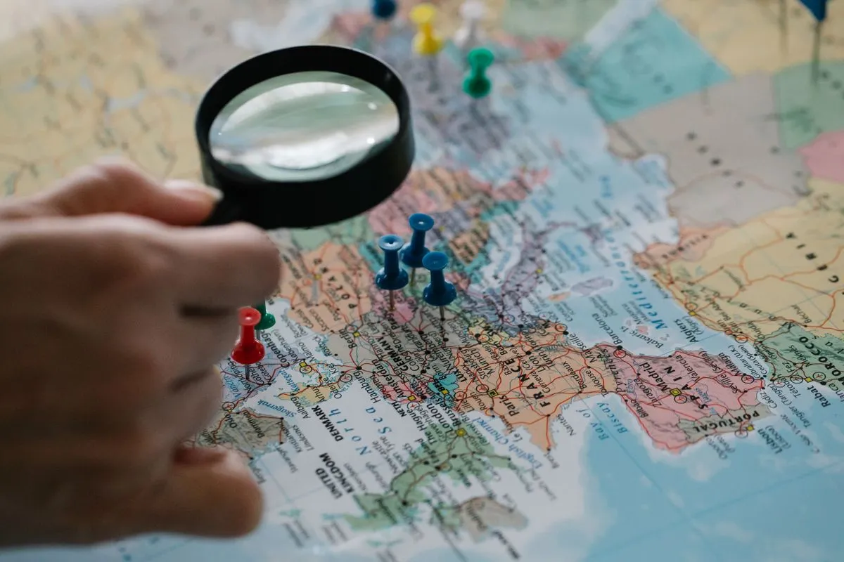 Magnifying glass over map pins representing travel search channels