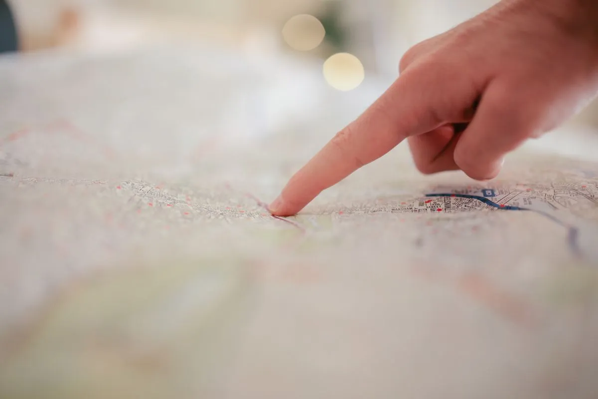 Hand pointing at a city map with destinations highlighted